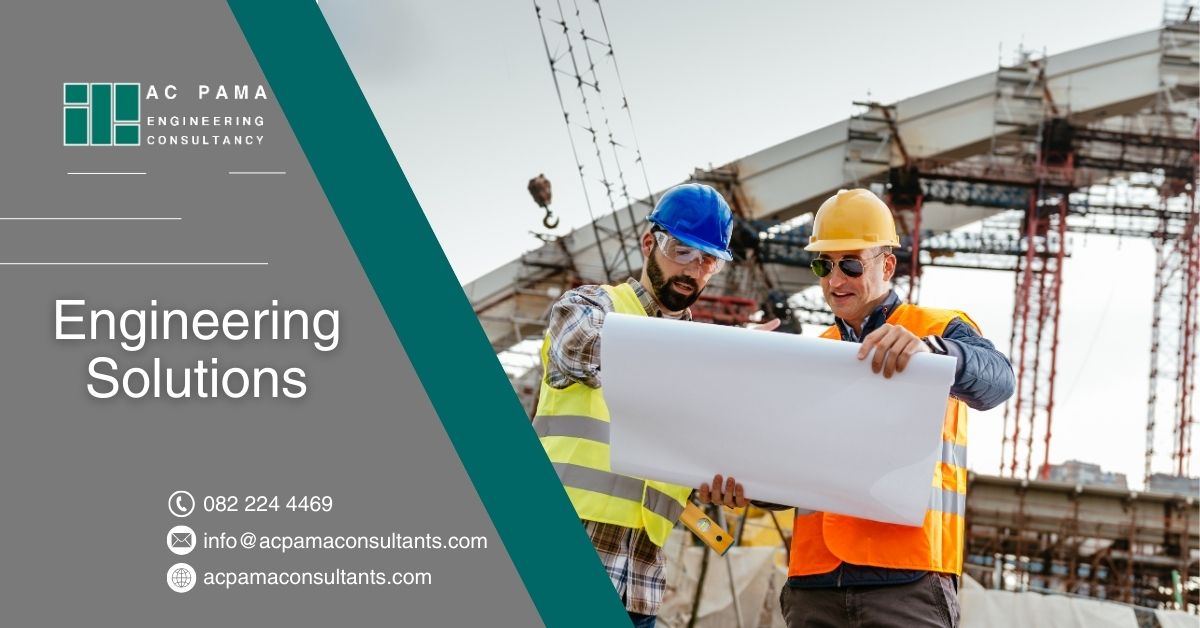 Two engineers looking at bluerpints to provide engineering solutions from concept to completion.